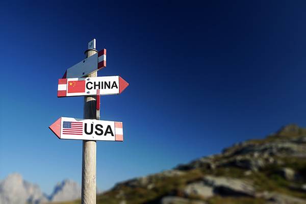 USA and Chinese flags on signpost