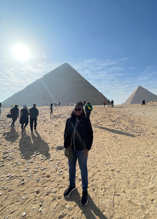 Dr. Stacy Blake-Beard standing in front of pyramids